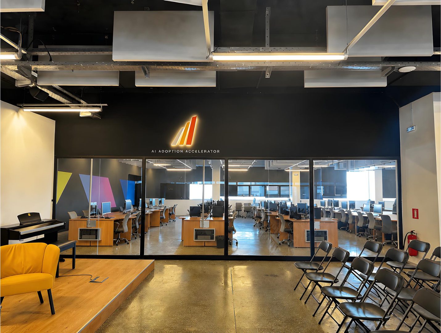 The A³ campus: the AI Adoption Accelerator room, its stage and the lab behind the glass
